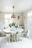 Round table and metal chairs in rustic dining room