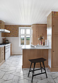 Modern kitchen with wooden cabinets and breakfast bar