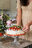 Strawberry cake on glass cake stand