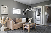 Pale sofa and coffee table in living room with grey walls