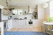 Bright kitchen with board floor and blue-and-white rug