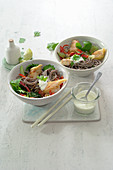Asian soba noodles with fish, ginger and sprouts