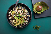 Vegan beluga lentil and wheat salad with avocado and spring onions