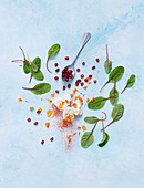 Feta cheese, flower petals, pomegranate seeds and sorrel leaves
