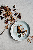 Chocolate pieces and dishes with cocoa over light background