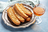 Biscotti, traditional Italian almond biscuits, with a glass of santo sweet wine