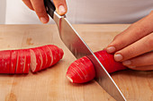 A radish being sliced