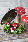Small New Year arrangement: fly agaric ornaments in silver caviar dish