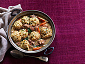 Slow-cooked pork and apple pot stew with thyme dumplings