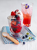 Vanilla ice cream with summer berries and an edible biscuit spoon