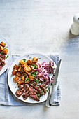 Smoky steak with Cajun potatoes and spicy slaw