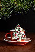 Christmas tree gingerbread cookie decorated with sugar sprinkles and icing