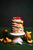 Pancakes cake with sweet creamy cheese and peaches