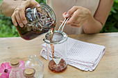 Preparing mallow toner: strain mallow flowers out of distilled water and alcohol