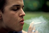 Teenage boy smoking a joint