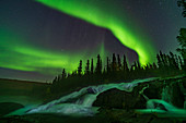 Aurora curtains over Ramparts Falls, Canada