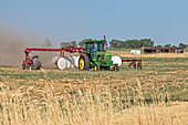 Tractor raking hay