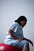 Pregnant woman sitting on birthing ball