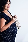 Pregnant woman holding soft toy