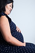 Pregnant woman holding her abdomen