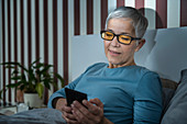 Mature woman wearing blue light blocking glasses