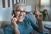Smiling mature woman talking over phone