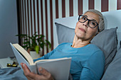 Woman reading in bed