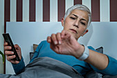 Senior woman checking smart watch sleep tracker
