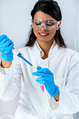 Researcher pipetting sample