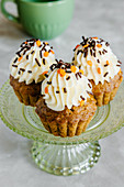 Spiced carrot and nut Autumn cupcakes, decorated with cream cheese frosting and sprinkles