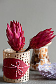 Protea flowers in decorated jar
