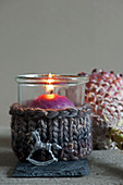 Candle lantern with knitted cover and tiny rocking horse decoration