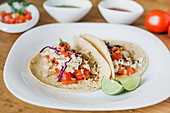 Mexican tacos with vegetable filling served with slices of green lime