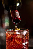 Alkohol in Cocktailglas zugiessen
