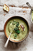 Broccoli soup on a cloth with croutons