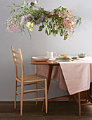 Wreath of flowers suspended over dining table