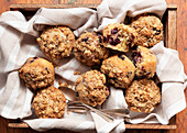 Mixed berry and oat muffins on a wooden tray