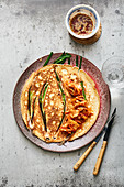 Korean pancakes with kimchi, spring onions and soy sauce