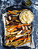 Oven-roasted vegetables on mashed potatoes and beans with chive oil