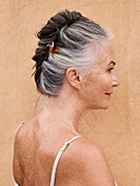 A grey-haired woman with her hair pinned up