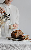 Woman pouring coffee, banana bread with sesame seeds