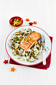 Salmon on green ribbon noodles with cheese sauce