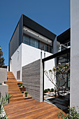 Wooden steps outside modern architect-designed house with courtyard