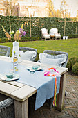 Wooden table and rattan chairs on terrace