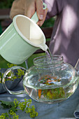 Brewing flower tea in a glass jug