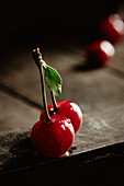 Two sour cherries with water drop