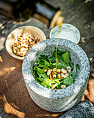 Ingredients for lovage pesto in a mortar