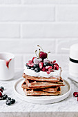 Vegan waffles with cream and fruit (raspberries, blueberries, cherries)