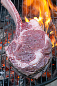 Tomahawk steak on charcoal grill
