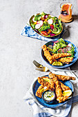 Fish fillets in a crispy crust with dip and mixed salad
